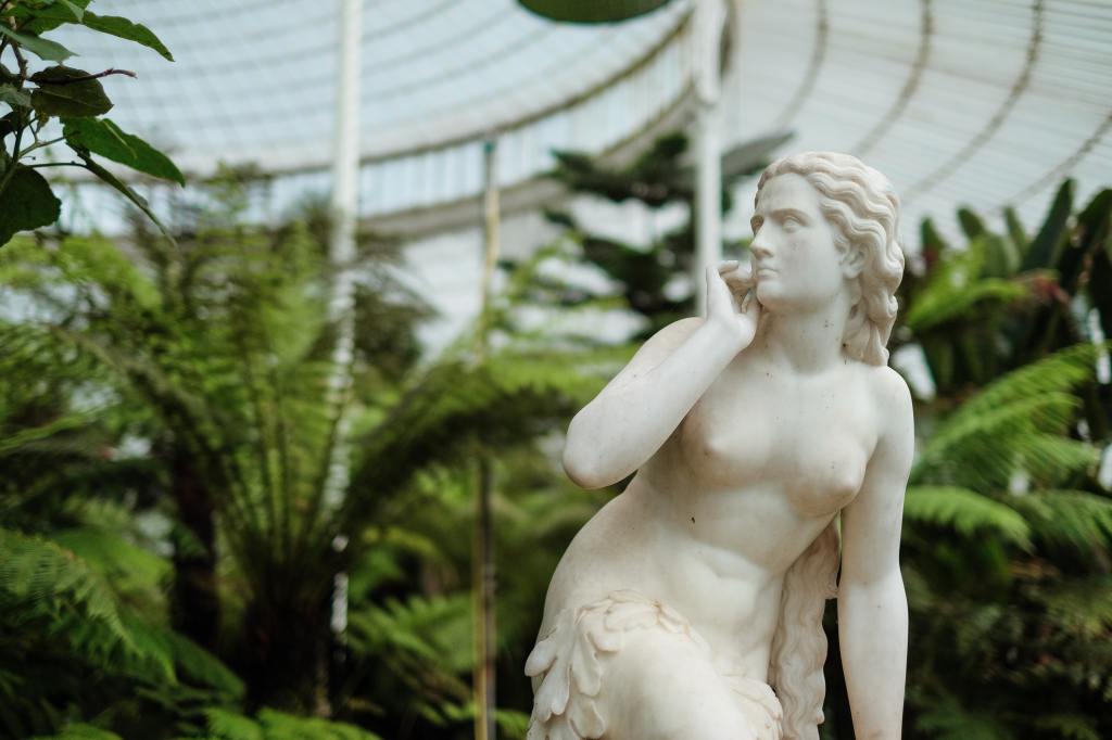 Marble Statue of Naked Female Human with long wavy hair looking towards the left